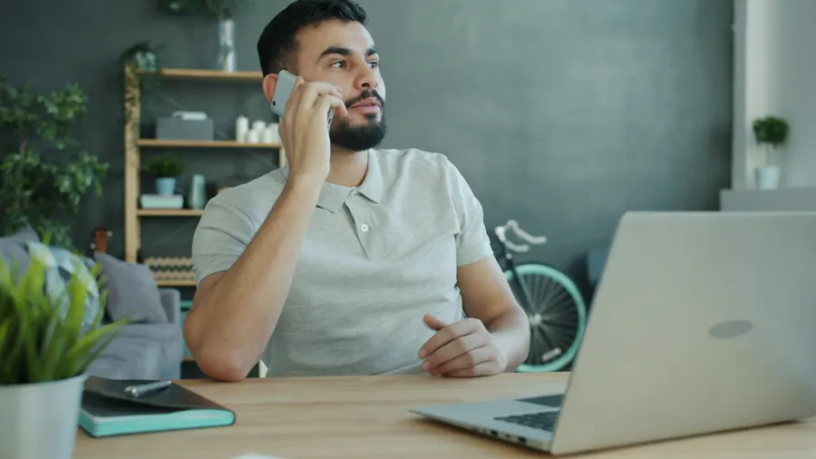 Man on a phone call at his desk